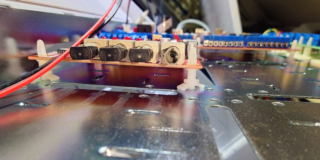 Close-up of electronic circuit board with black components and wires.
