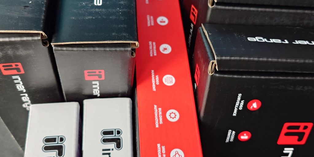 Boxes of Inner Range security system components.
