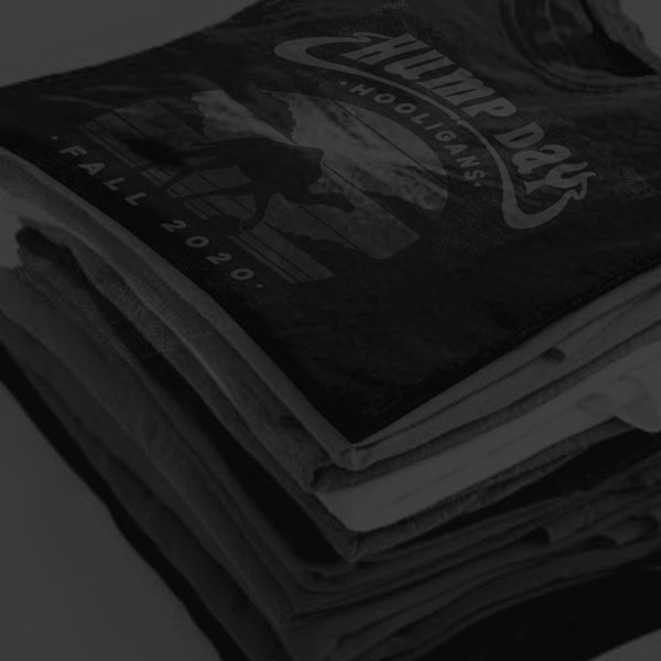 Stack of folded t-shirts with a graphic design.