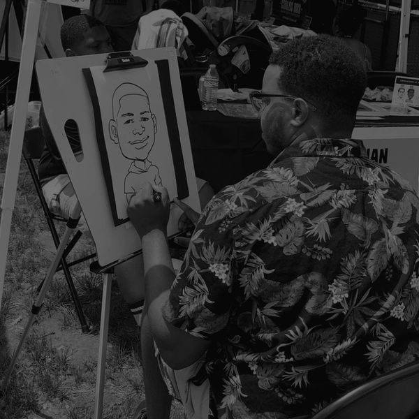 Artist drawing a caricature outdoors.