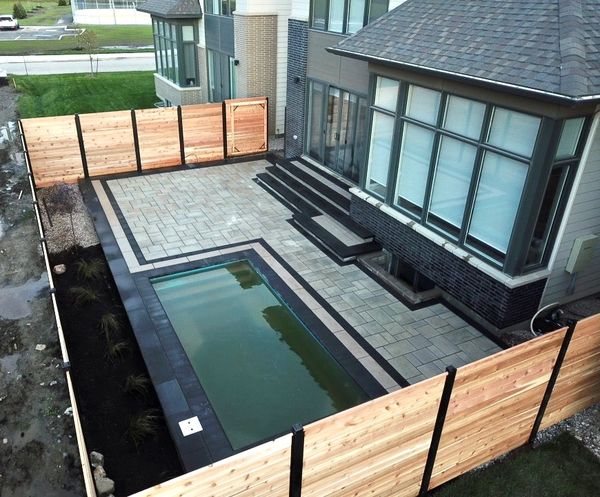 Backyard outdoor living space with pool and Techo-Bloc Interlock
