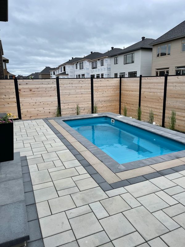 Perfect backyard retreat with pool, interlock and lighting