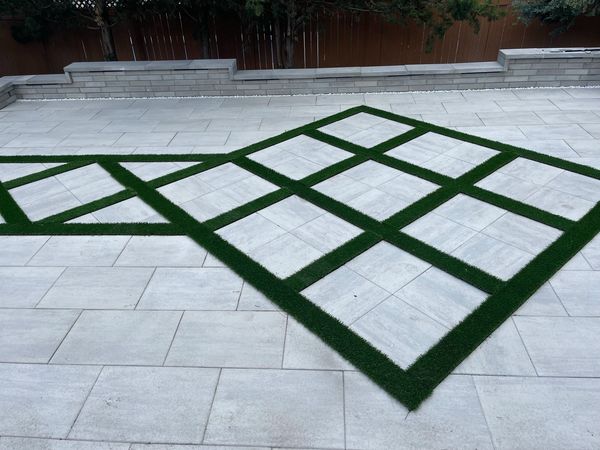 Interlock patio with artificial grass in-lay and retaining wall in Stittsville