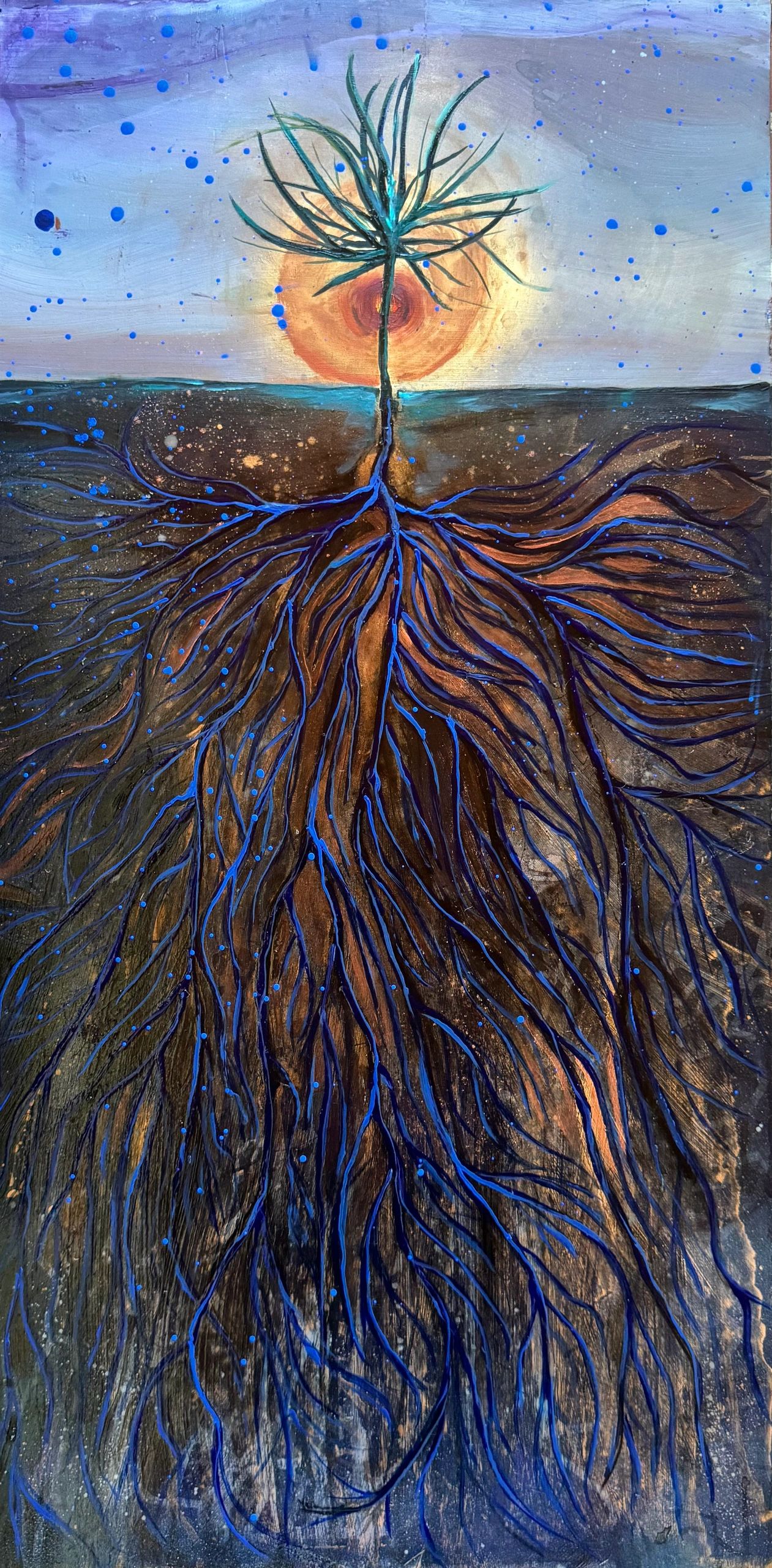 Artistic tree with vibrant blue roots glowing beneath the soil under an orange sun.