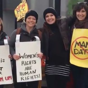Group of people holding signs at the Women's Rally in January 2017