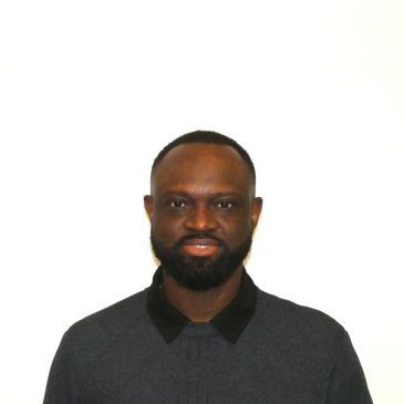 Portrait of a man smiling at the camera.