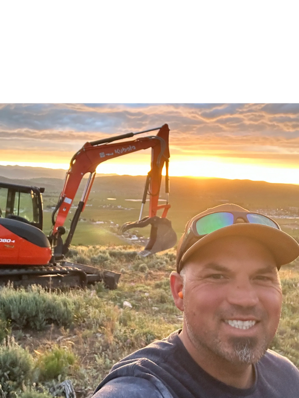 Ben in his element on the mountain with an excavator