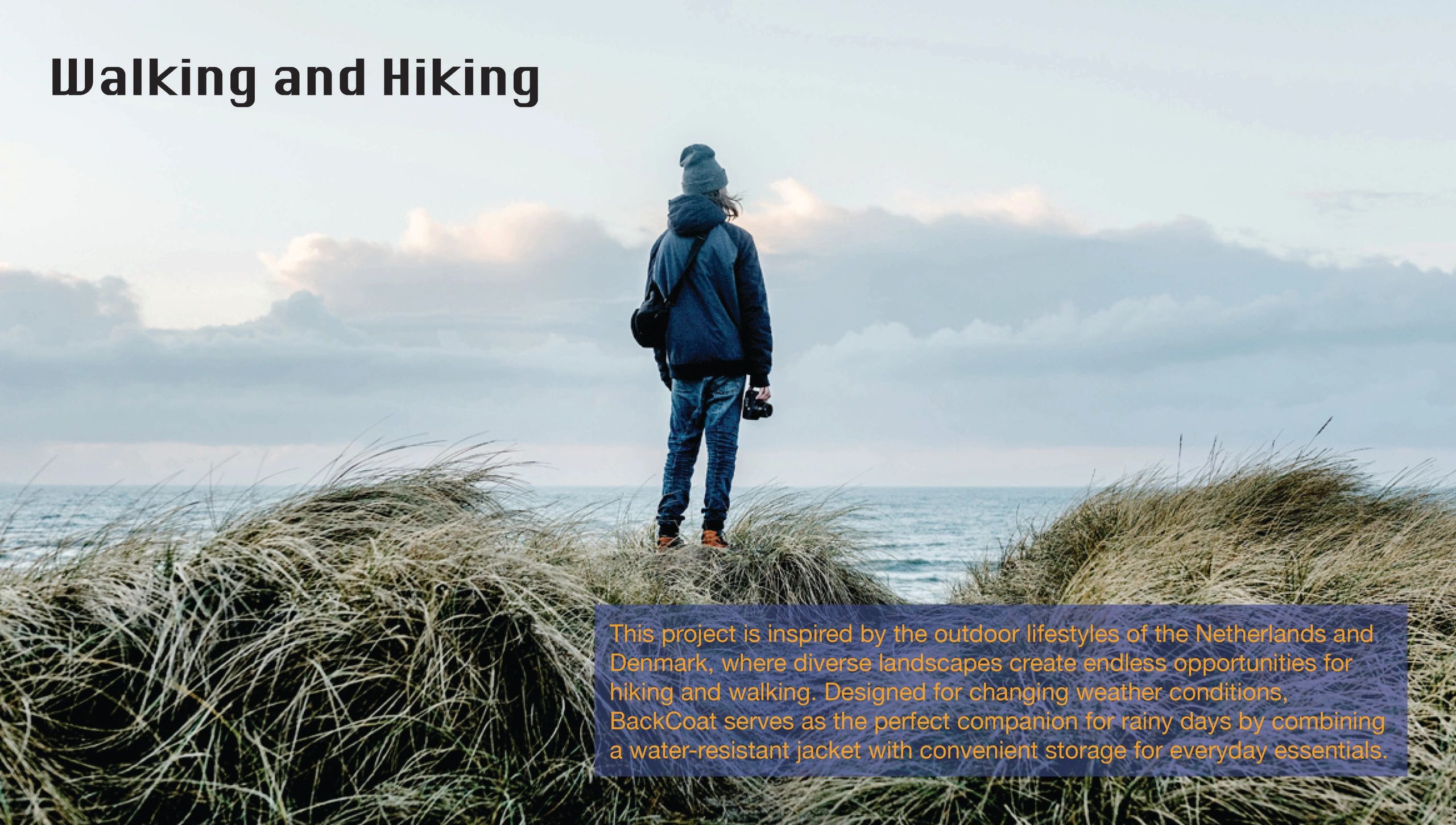 Person standing on grassy dunes near the sea, enjoying hiking and walking.