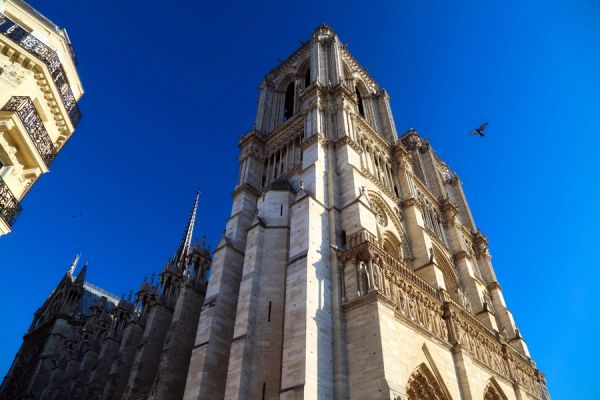 Gothic cathedral tower against a clear blue sky.
