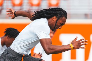 Athlete sprinting intensely during a sports practice session.