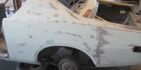 Car body undergoing repair and sanding.