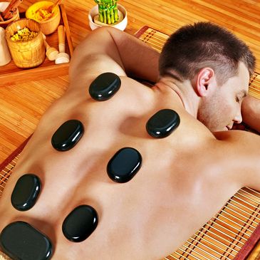 Man getting a hot rock massage at Bodywork by Rog at SoHo in Tampa FL 33609 Best Massage in Tampa