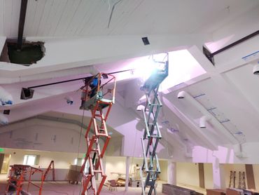 Welders using a platform lift