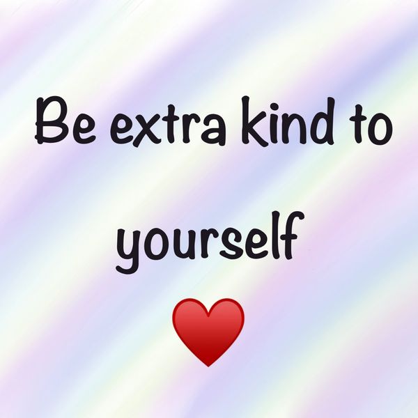 The words "be extra kind to yourself" with a heart on a pastel rainbow background