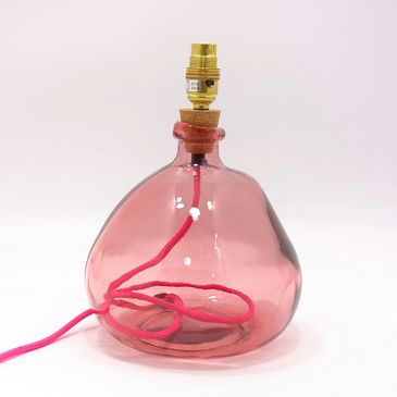 Pink irregular-shaped glass lamp base with pink flex and brass fitting.