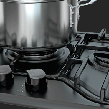 Close-up of a stainless steel pot on a modern gas stove.