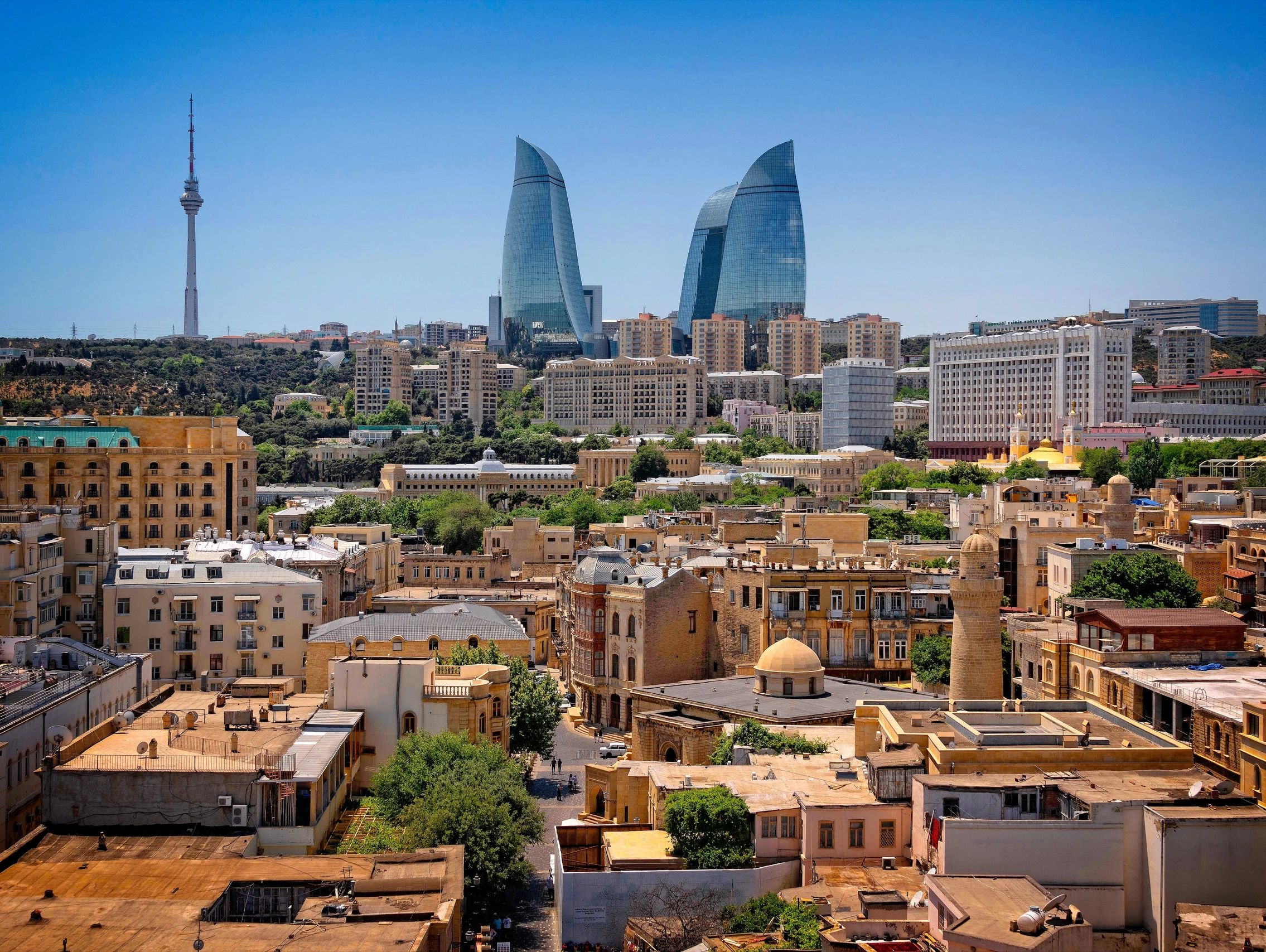 Baku's Flame Towers alongside historic architecture, showcasing a modern and traditional blend.