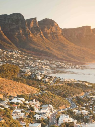 Breathtaking view of mountains meeting the ocean in South Africa, perfect for a romantic escape.