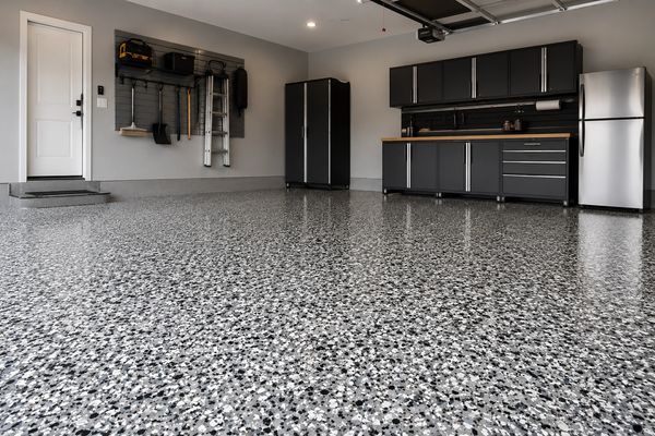 Modern garage with polished epoxy flooring and organized storage cabinets.
