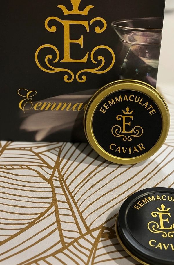 Elegant Eemmaculate Caviar tins and packaging with gold and black design.