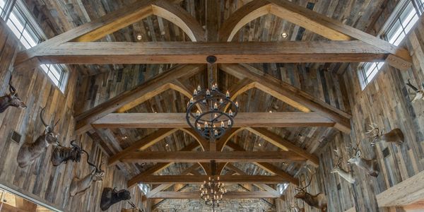 exposed wood ceiling beams with barnwood wall and ceiling paneling by The Woodshop of Texas