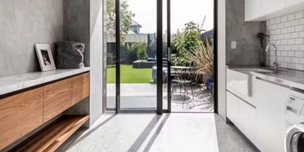 Modern kitchen with sliding glass doors leading to a sunny outdoor patio.