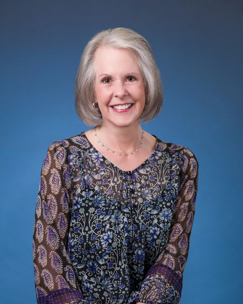 Duckworth Casual Headshot Blue Background.jpg