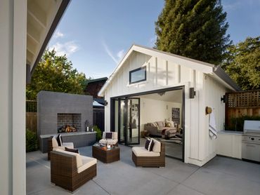 white coach house in backyard