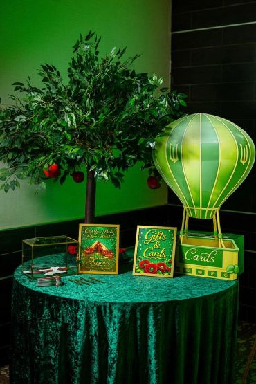 Decorative table with a tree, hot air balloon card box, and gift signs.