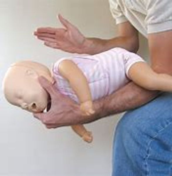 practicing CPR on an infant mannequin