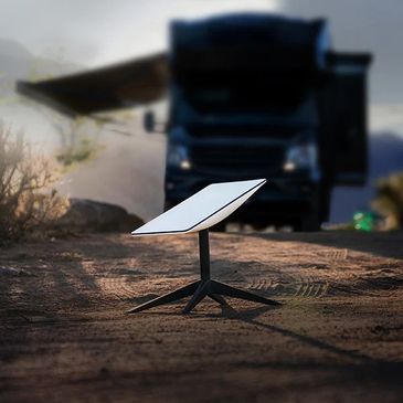 Solar panel charging device outdoors near a vehicle.