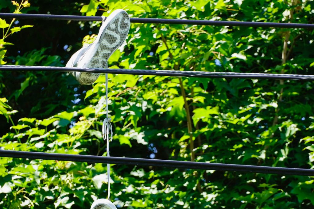 Pair of shoes tied together hanging from power lines.