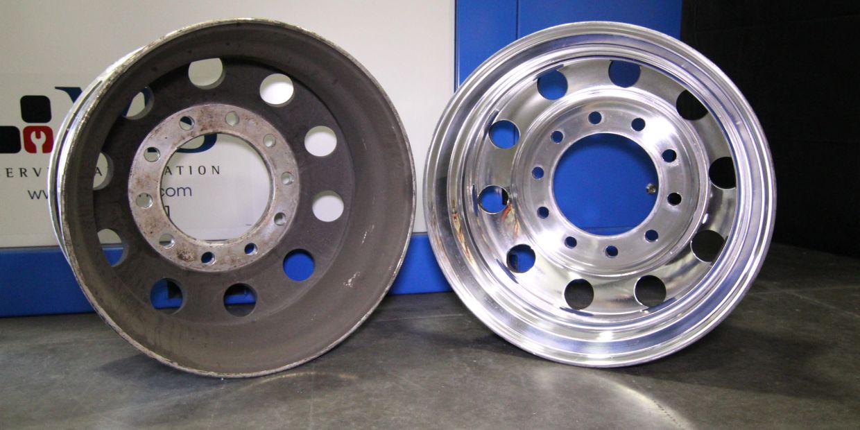 Two metal wheel rims, one old and one polished.