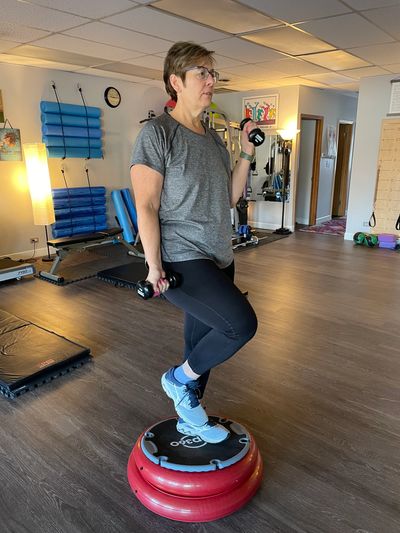 Molly works on her balance as well as her lower and upper body