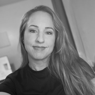 Black and white portrait of a woman smiling.