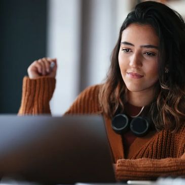 woman smiling in front of laptop