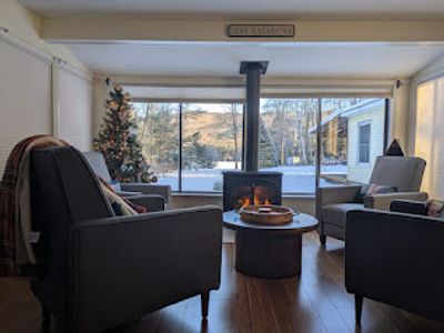 Conversation Circle of 4 recliners by gas stove overlooking back yard view of Lake Kanasatka and Red