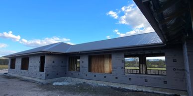 House under construction with plywood and wrap installed.