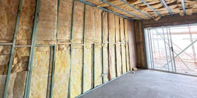 Interior wall insulation installation in progress.