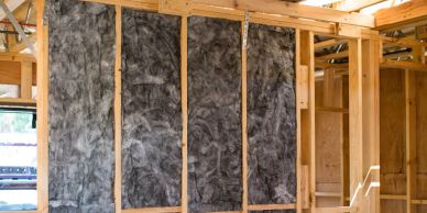 Wall insulation installed in a wooden frame.