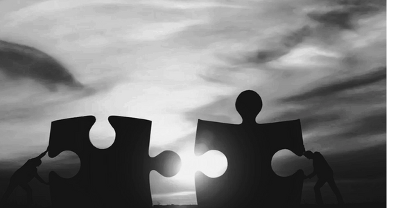 closeup of two pieces of puzzle Mediation Conversation = Resolution Dispute Resolution Services 