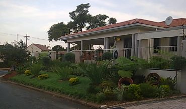 A house with a lush front garden.