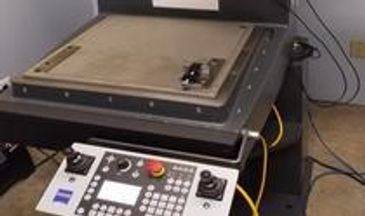 Close-up of a precision machine bed and control panel.