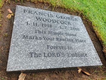 A gravestone for Francis George Woodcock with a heartfelt inscription.