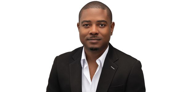 Professional man in black blazer and white shirt posing against white background.