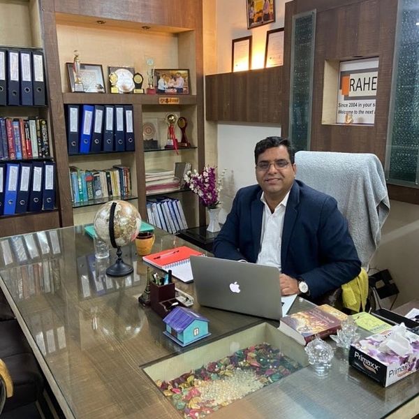 Man sitting at a desk in a well-organized office.