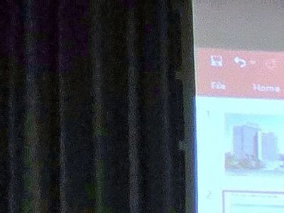 Presentation slide with city buildings shown.