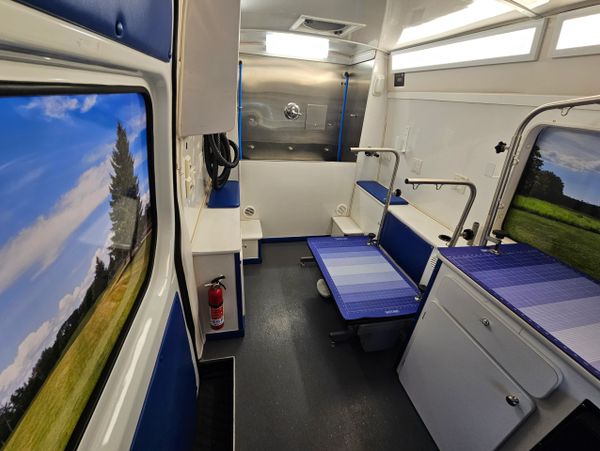 Interior of a clean, modern medical or veterinary examination room with scenic window views.