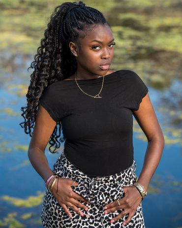 Girl with serious look standing by a stream