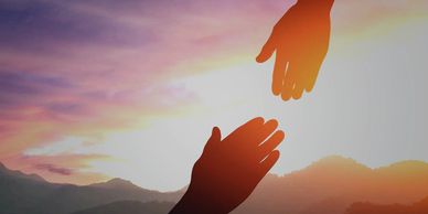 image of two hands reaching toward each other